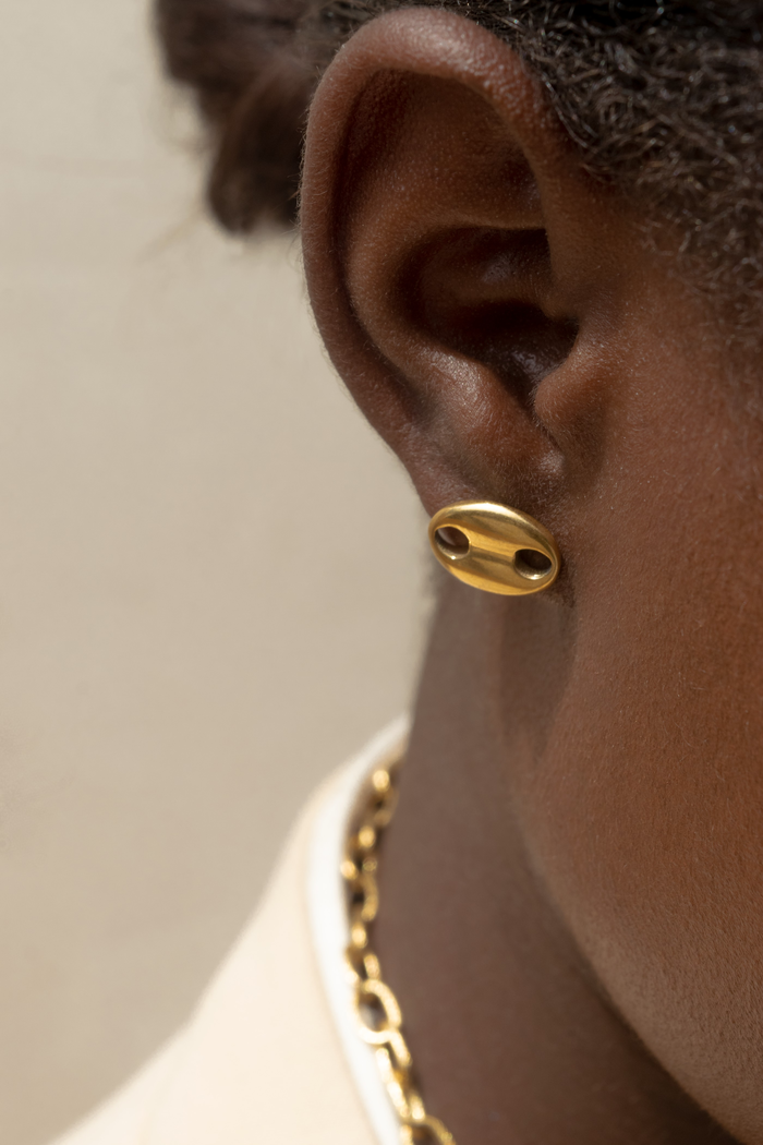 Gold pebble stud earring on model